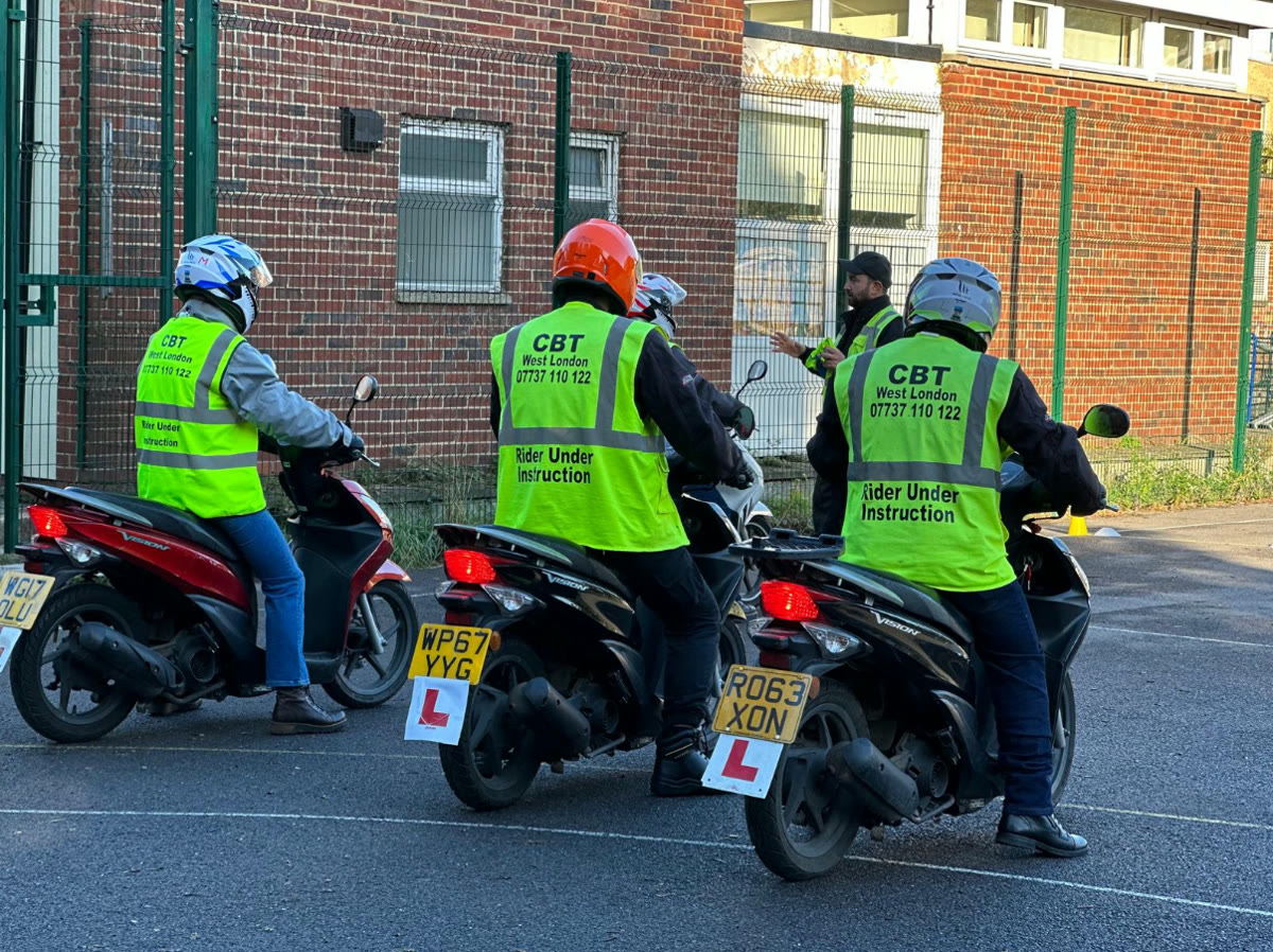 CBT West London riders in hi-vis vests on the training pad